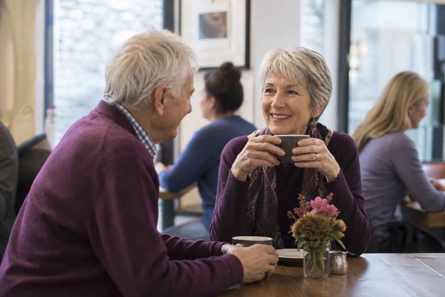 Widowed woman using a dating site at home with a cup of tea